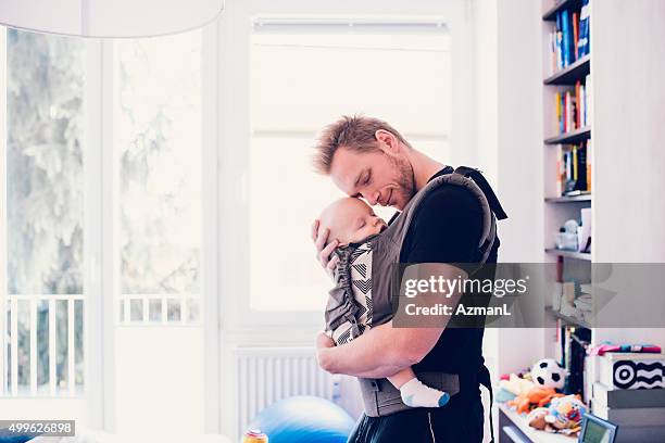 he means everything to him - baby carrier stock pictures, royalty-free photos & images