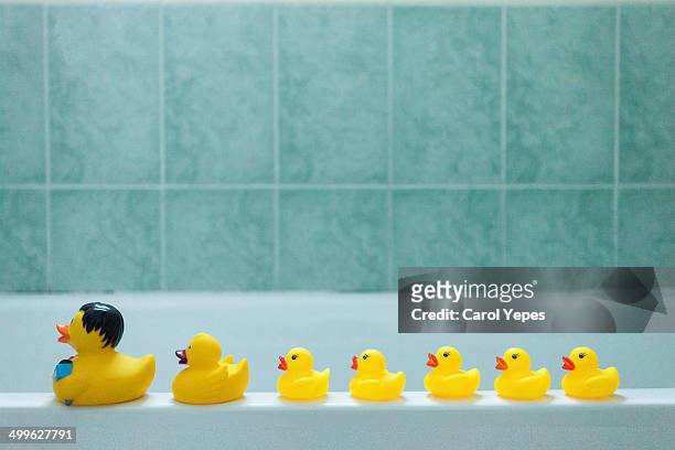 yellow rubber ducks in a row - rubber ducks in a row stock pictures, royalty-free photos & images