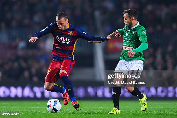 Sandro Ramirez of FC Barcelona competes for the ball with Moraga of Villanovense during the Copa del Rey Round of 32 second leg match betwen FC...