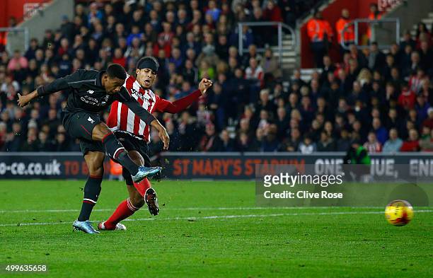 Jordon Ibe of Liverpool shoots past Virgil van Dijk of Southampton as he scores their fifth goal during the Capital One Cup quarter final match...