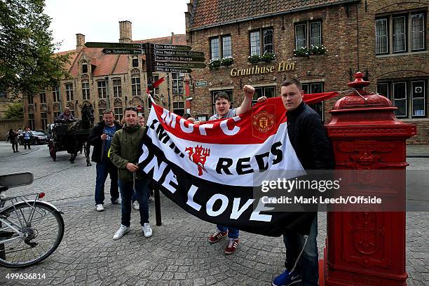 Club Brugge v Manchester United - Manchester United fans in Brugge City centre pose as a pony and trap pass by prior to the UEFA Champions League...