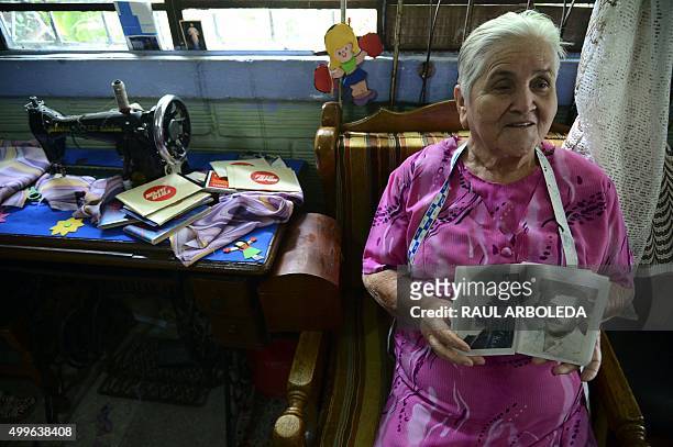 Irene Gaviria shows an album with pictures of late Colombian drug lord Pablo Escobar at her home in the Pablo Escobar neighborhood in Medellin,...