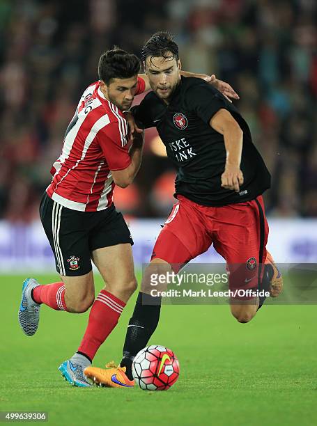 Shane Long of Southampton tangles with Tim Sparv of FC Midtjylland during the UEFA Europa League Play Off Round 1st Leg match between Southampton and...