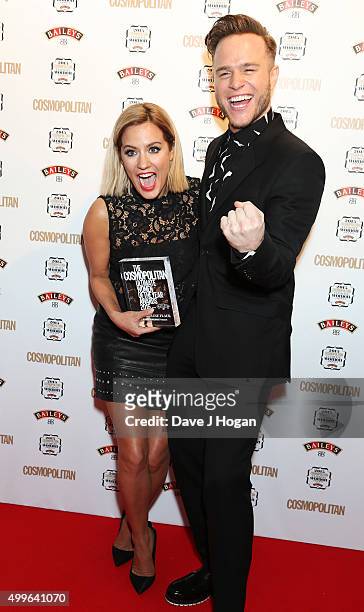 Caroline Flack and Olly Murs pose for a photo with the award for TV Personality during the Cosmopolitan Ultimate Women Of The Year Awards at One...