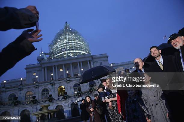 Speaker of the House Paul Ryan poses for photographs with members of the Alaska delegation during the Capitol Christmas tree lighting ceremony on the...
