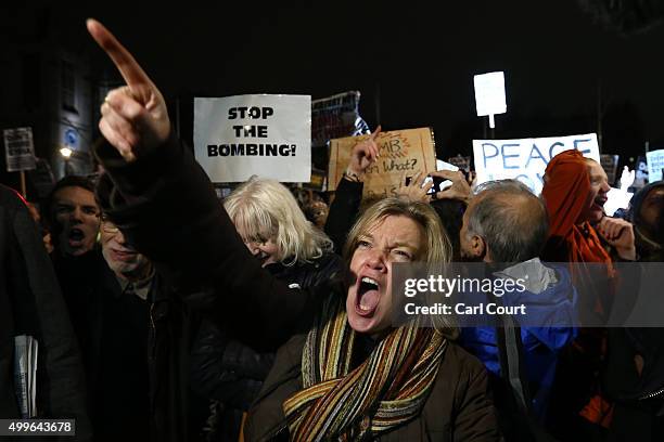 Demonstrator shouts as she protests against British airstrikes against Islamic State targets in Syria outside Parliament on December 2, 2015 in...