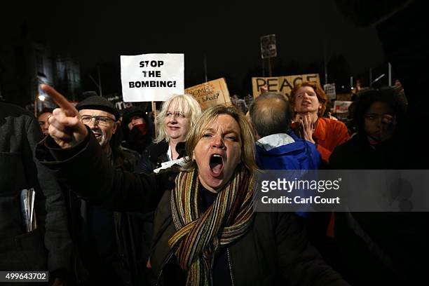 Demonstrator shouts as she protests against British airstrikes against Islamic State targets in Syria outside Parliament on December 2, 2015 in...