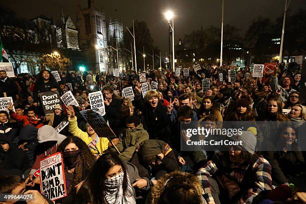 Demonstrators protest against British airstrikes against Islamic State targets in Syria outside Parliament on December 2, 2015 in London, England....