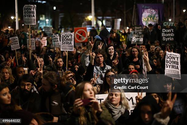 Demonstrators protest against British airstrikes against Islamic State targets in Syria outside Parliament on December 2, 2015 in London, England....
