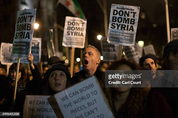 Demonstrators protest against British airstrikes against Islamic State targets in Syria outside Parliament on December 2, 2015 in London, England....