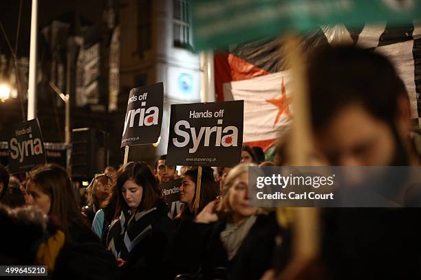 Demonstrators protest against British airstrikes against Islamic State targets in Syria outside Parliament on December 2, 2015 in London, England....