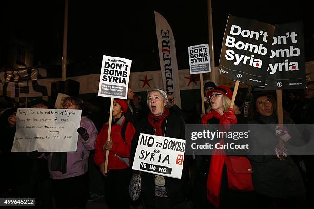 Demonstrators protest against British airstrikes against Islamic State targets in Syria outside Parliament on December 2, 2015 in London, England....