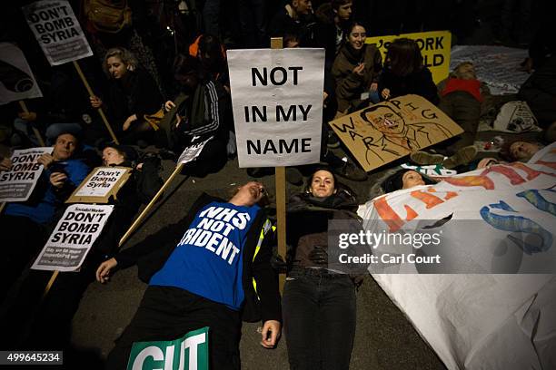 Demonstrators protest against British airstrikes against Islamic State targets in Syria outside Parliament on December 2, 2015 in London, England....