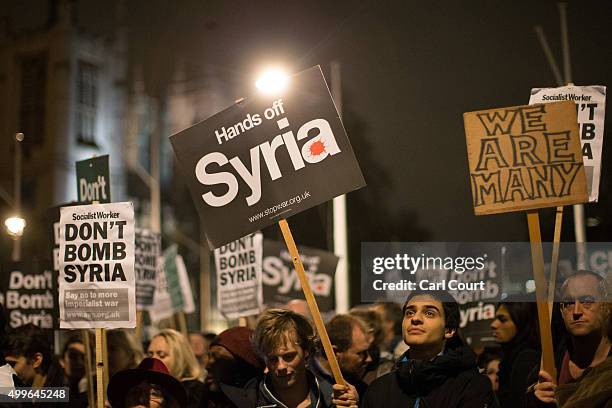 Demonstrators protest against British airstrikes against Islamic State targets in Syria outside Parliament on December 2, 2015 in London, England....