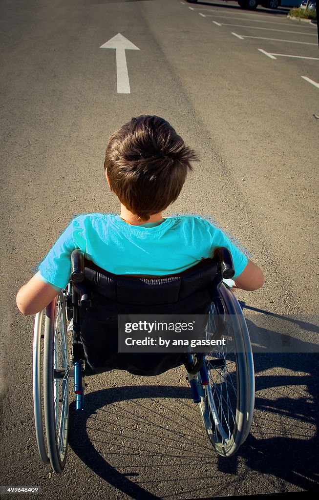 Boy in wheelchair goes ahead