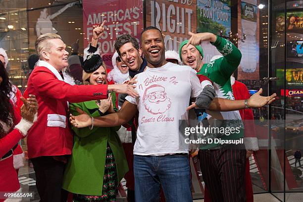 Sam Hollander, AJ Calloway, Kevin Griffin, and Mark McGrath pose for a photo on the set of "Extra" at their New York studios at H&M in Times Square...