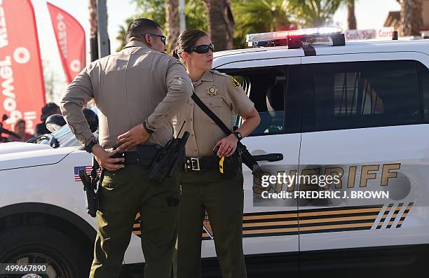 Armed officers from the Sheriff's department on patrol near the scene of the crime in San Bernardino, California on December 2, 2015. A man and a...
