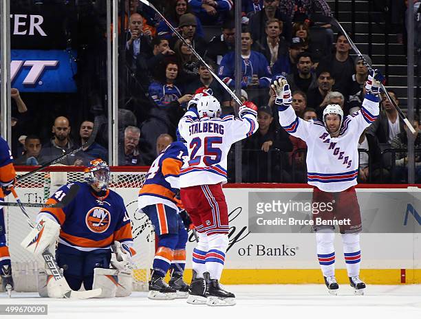 Viktor Stalberg of the New York Rangers scores at 18:37 of the second period against Jaroslav Halak of the New York Islanders and is joined by...