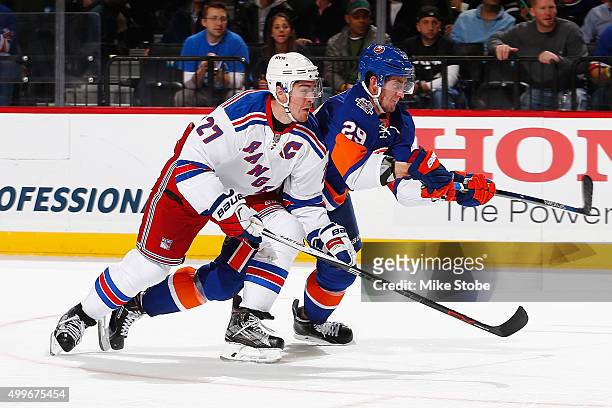 Ryan McDonagh of the New York Rangers skates against Brock Nelson of the New York Islanders during the game at the Barclays Center on December 2,...