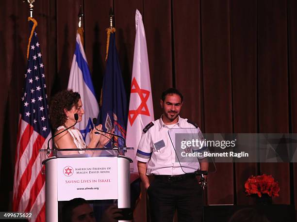 Humanitarian of the Year Award Honoree Meredith Berkman and Hananel Alvo speak on stage at AFMDA Red Star Gala at The Grand Hyatt New York on...