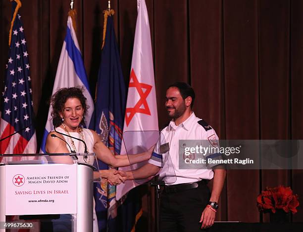 Humanitarian of the Year Award Honoree Meredith Berkman and Hananel Alvo speak on stage at AFMDA Red Star Gala at The Grand Hyatt New York on...