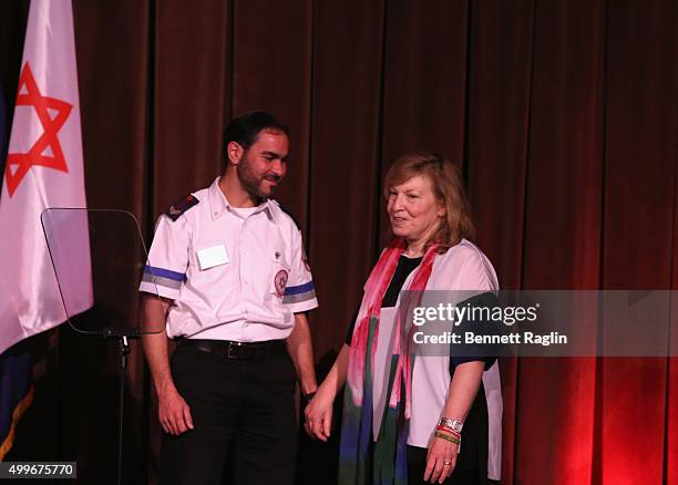 National Board Member Donna Fried Calcaterra and Hananel Alvo speak on stage at AFMDA Red Star Gala at The Grand Hyatt New York on December 2, 2015...