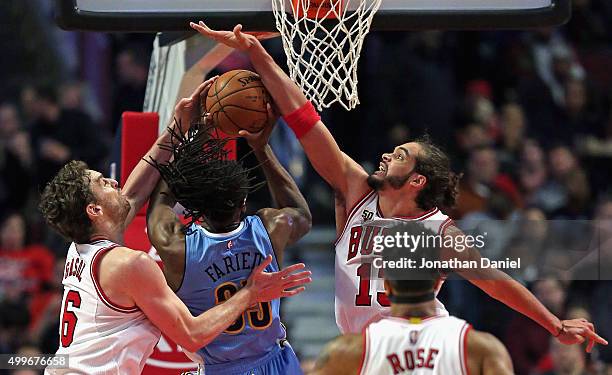 Kenneth Faried of the Denver Nuggets tries to get off a shot between Pau Gasol and Joakim Noah of the Chicago Bulls at the United Center on December...