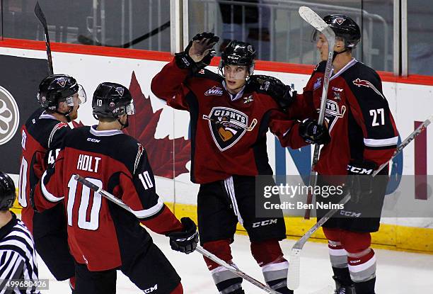 Ty Ronning of the Vancouver Giants celebrates his goal against the Medicine Hat Tigers with teammates Trevor Cox, Dawson Holt and Ben Thomas during...