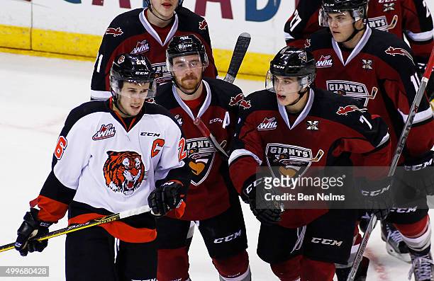 Ty Ronning of the Vancouver Giants celebrates his goal near Cole Sanford of the Medicine Hat Tigers with teammate Trevor Cox during the second period...