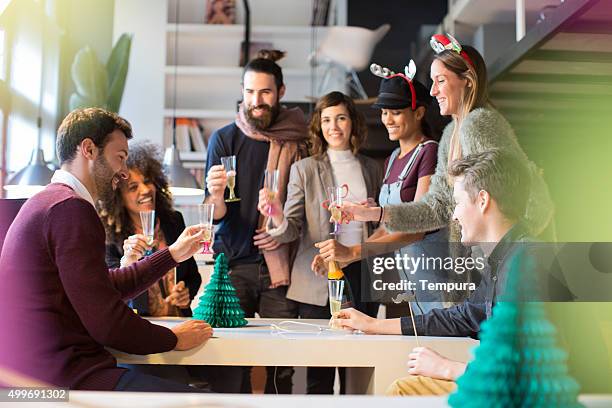 celebrating new year and christimas in the office. - christmas party office stock pictures, royalty-free photos & images