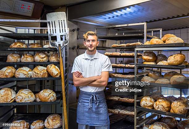 baker in his bakery baking bread - man tray food holding stockfoto's en -beelden