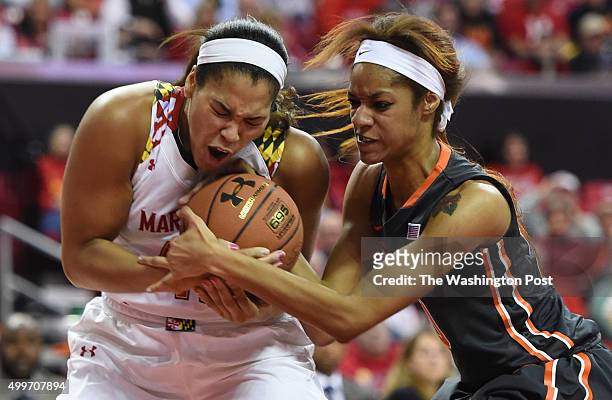 Maryland center Brionna Jones and Syracuse center Briana Day battle for a loose ball during second half action on December 2, 2015 in College Park,...