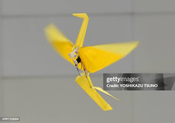 Japan's electronics parts maker Rohm demonstrates a remote controlled flying paper crane "Origami", weighing only 31g, at the annual International...