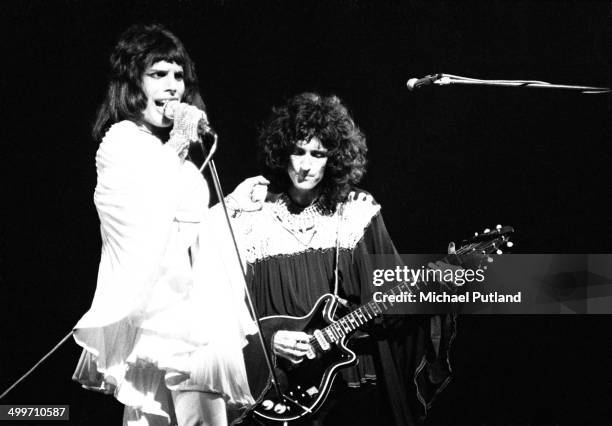 Singer Freddie Mercury and guitarst Brian May of British rock group Queen perform on stage in London, 1974.