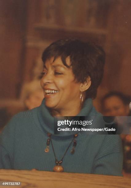 African-American playwright, actress, poet and activist Ruby Dee smiling and speaking at a podium, 1990.