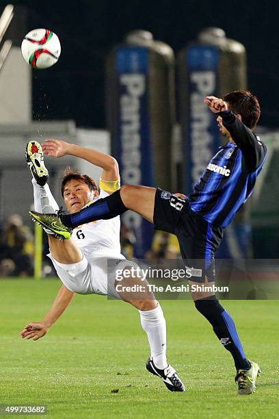 Toshihiro Aoyama of Sanfrecce Hiroshima and Kotaro Omori of Gamba Osaka compete for the ball during the J.League Championship Final frist leg match...