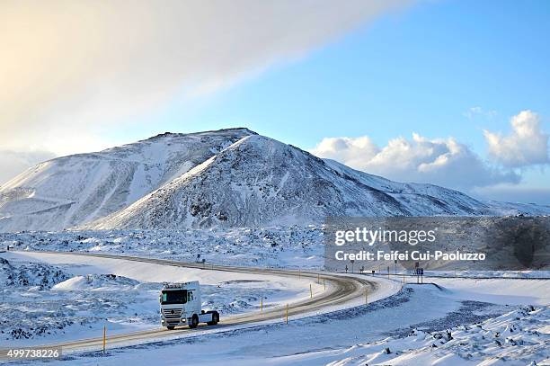 winding and snowy road to reykjavik iceland - slippery road sign stock pictures, royalty-free photos & images