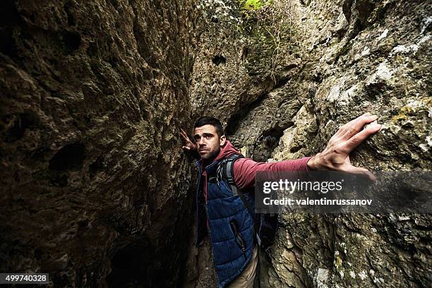 young man in cave - trapped wind stock pictures, royalty-free photos & images