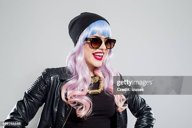 portrait of happy blue-pink hair carefree girl wearing leather jacket - funky hair studio shot stock pictures, royalty-free photos & images