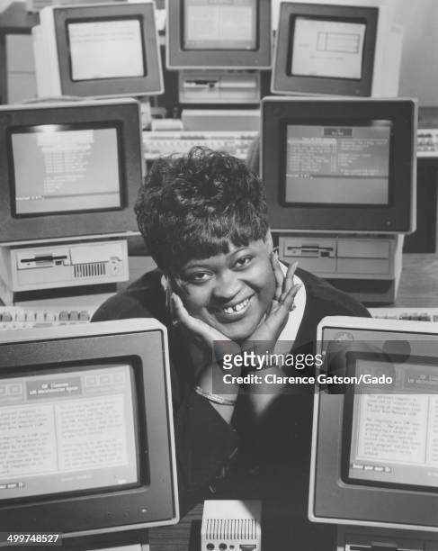 Dannette Evans smiling at a job training center, with International Business Machines computers, San Francisco, California, 1980.
