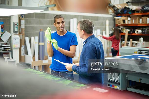 young man working at a signage company - part time worker stock pictures, royalty-free photos & images