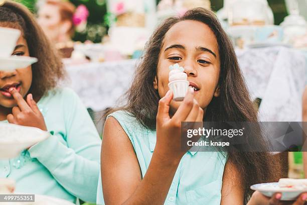 girls at a garden party with dessert table - tea party stock pictures, royalty-free photos & images