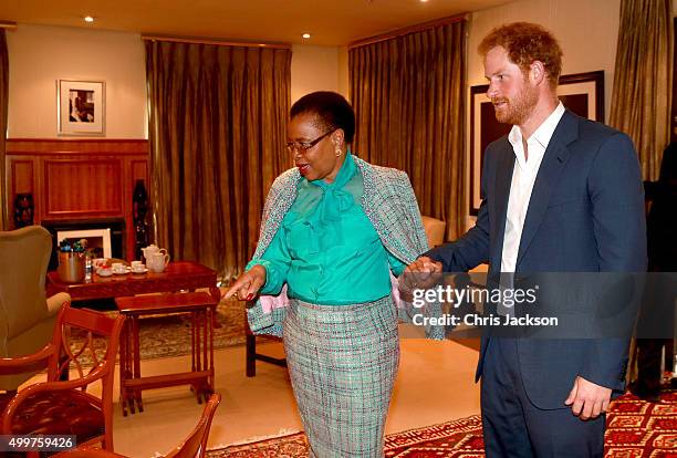 Prince Harry in Nelson Mandela's office with Graca Machel his widow at the Nelson Mandela Foundation Centre of Memory on December 3, 2015 in...