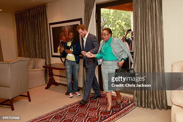 Prince Harry in Nelson Mandela's office with Graca Machel his widow at the Nelson Mandela Foundation Centre of Memory on December 3, 2015 in...