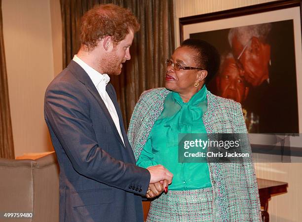 Prince Harry in Nelson Mandela's office with Graca Machel his widow at the Nelson Mandela Foundation Centre of Memory on December 3, 2015 in...