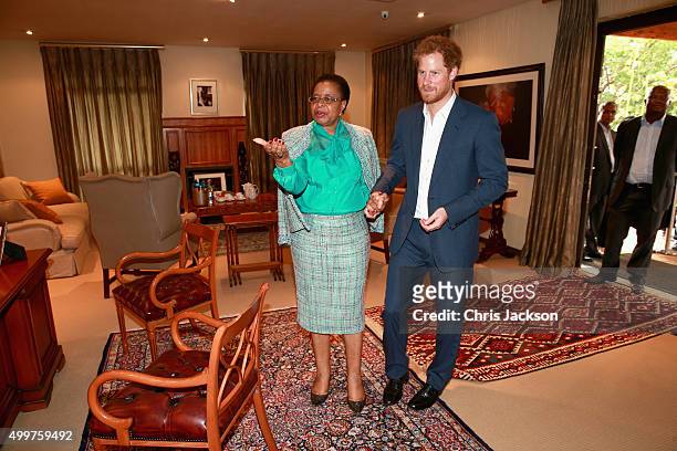 Prince Harry in Nelson Mandela's office with his widow Graca Machel at the Nelson Mandela Foundation Centre of Memory on December 3, 2015 in...