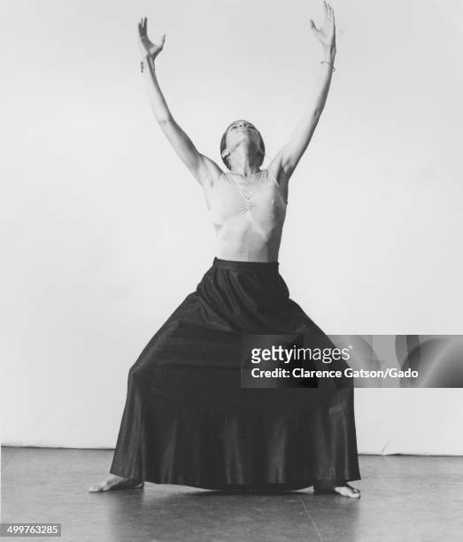 Halifu Osumare reaching skyward and performing a yoga pose, San Francisco, California, May 3, 1975.