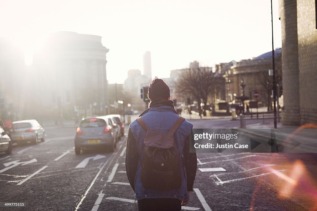 Man walking in the middle of a city road