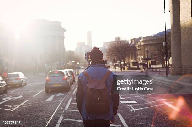 man walking in the middle of a city road - rezar stock pictures, royalty-free photos & images