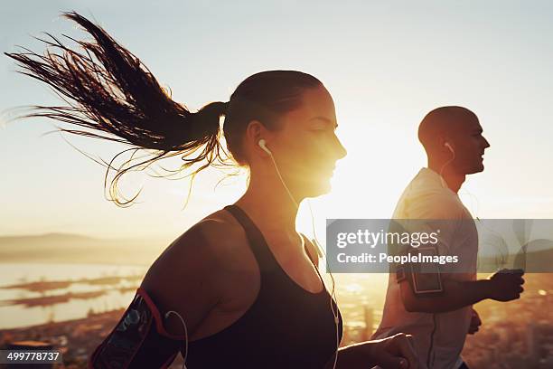 music motivates us - runner sunrise stock pictures, royalty-free photos & images